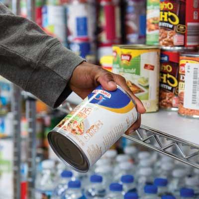 close up of hand holding can in ksu food pantry